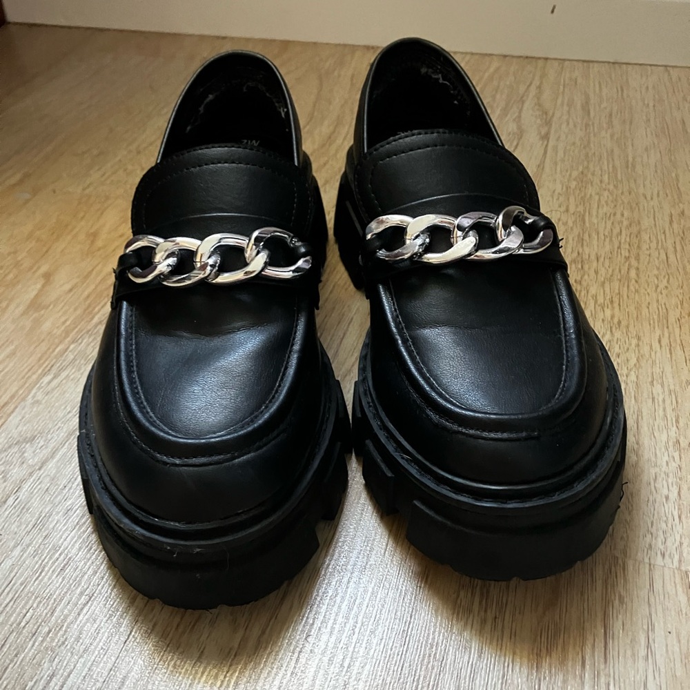 Black platform loafers with silver chain